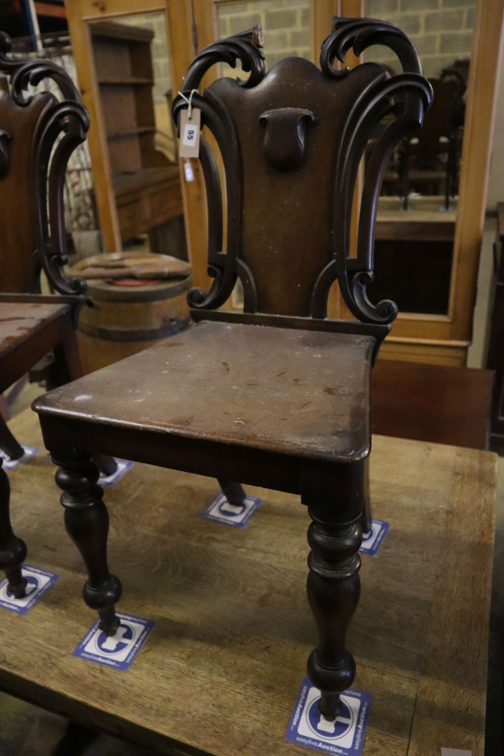 A pair of Victorian mahogany hall chairs (one a.f.)